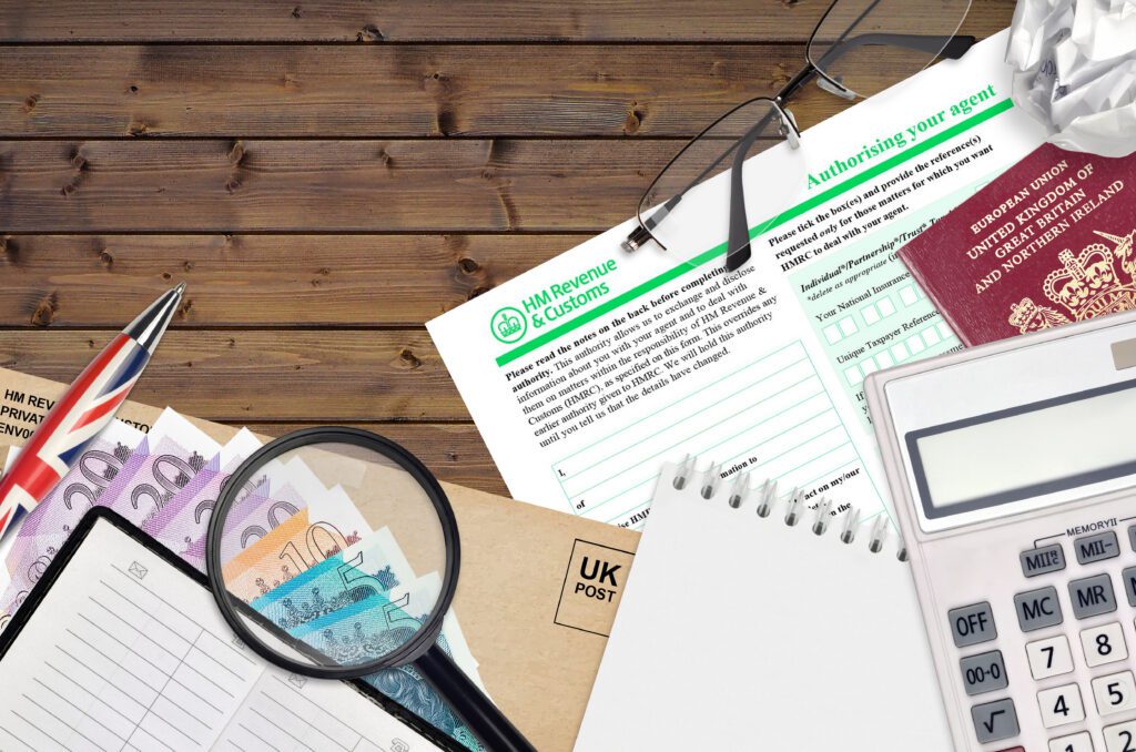 English form 64-8 Authorising your agent from HM revenue and customs lies on table with office items. HMRC paperwork and tax paying process in United Kingdom of Great Britain